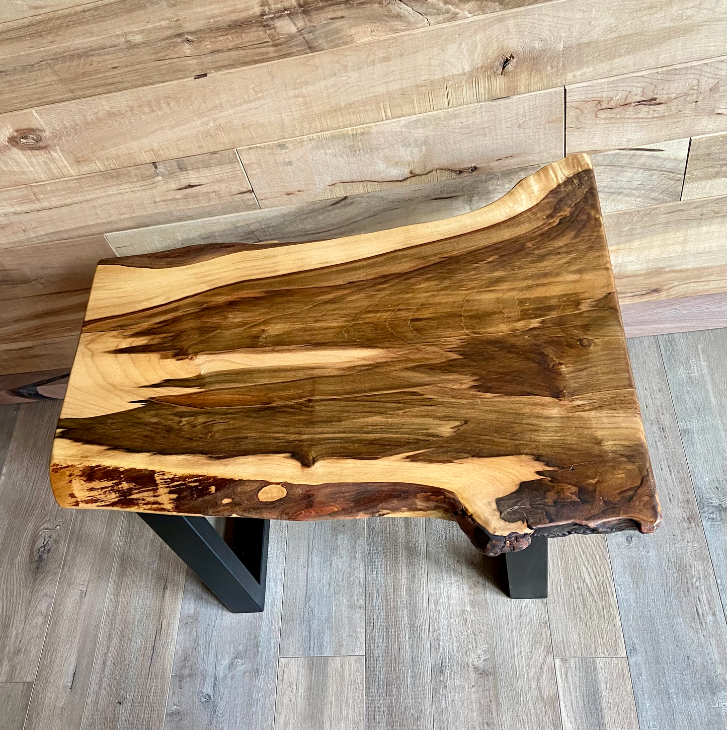 Detailed view of ambrosia maple wood grain, showing natural spalting, color variations, and organic patterns. live edge coffee table made from ambrosia maple, featuring unique grain patterns and a smooth, polished surface. Rustic and modern design. Handcrafted ambrosia maple coffee table styled in a modern living room with a cozy, rustic aesthetic. Top-down view of ambrosia maple coffee table, highlighting natural wood grain, warm tones, and live edge details.