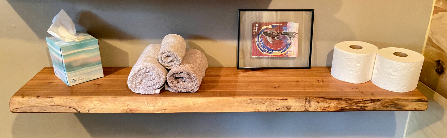 Close-up side view of a rustic live edge wood floating shelf showing natural grain and curvature.