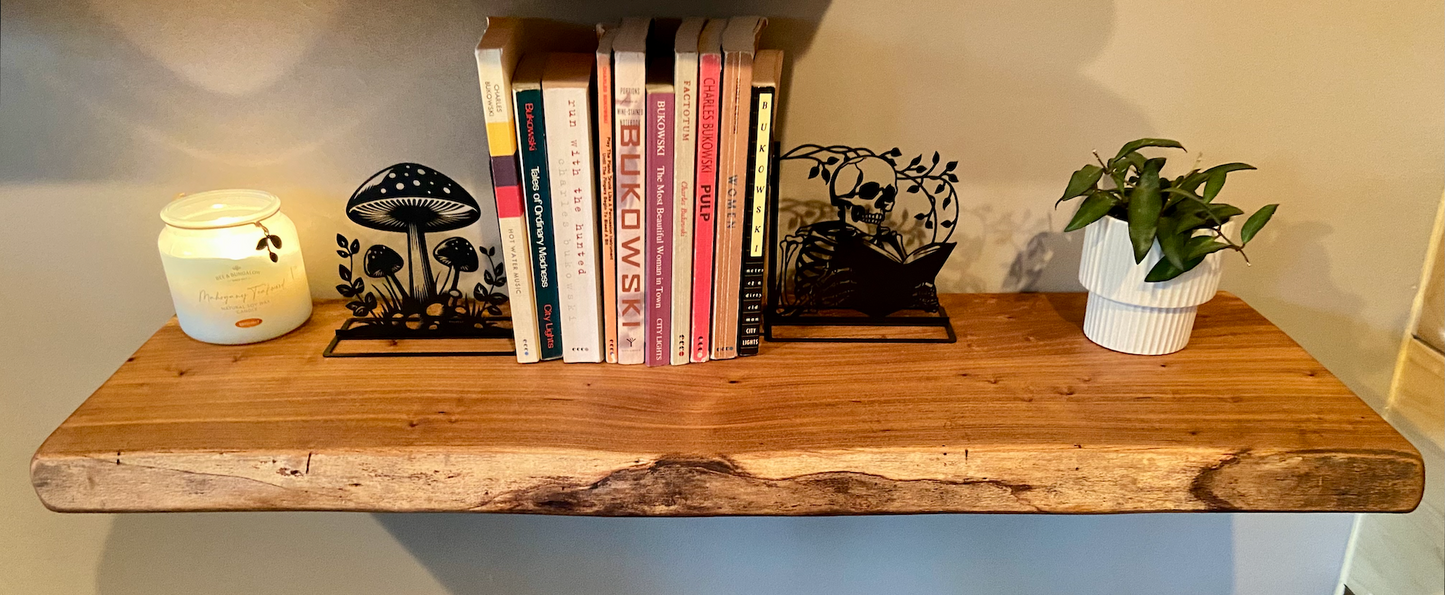 Close-up side view of a rustic live edge wood floating shelf showing natural grain and curvature.