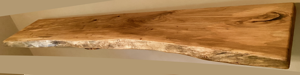 Custom live edge chestnut shelves with warm golden-brown tones and a natural edge. Solid chestnut wood, perfect for rustic and modern interiors.
