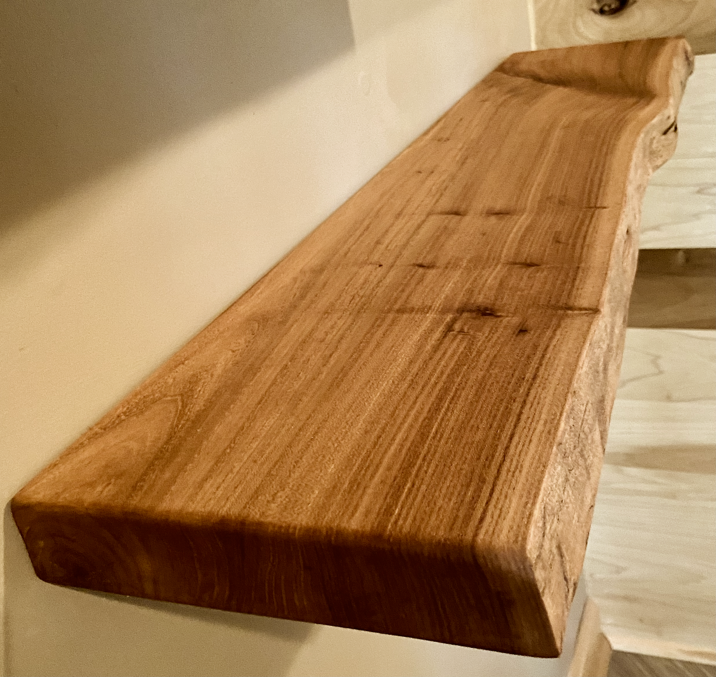 Custom live edge chestnut shelves with warm golden-brown tones and a natural edge. Solid chestnut wood, perfect for rustic and modern interiors.