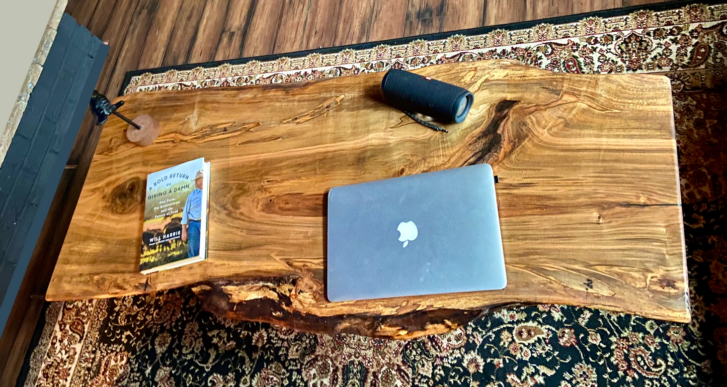 Top-down view of live edge ambrosia maple coffee table with household items, highlighting natural wood grain, and live edge details. Handcrafted ambrosia maple coffee table styled in a modern living room with a cozy, rustic aesthetic. Detailed view of ambrosia maple wood grain, showing natural spalting, color variations, and organic patterns. Curved live edge coffee table made from ambrosia maple, featuring unique grain patterns and a smooth, polished surface. Rustic and modern design.