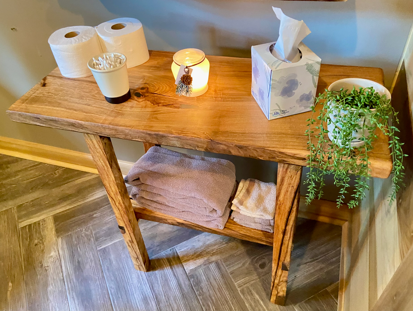 Top-down view of spalted maple sofa or console table with household items, highlighting natural wood grain, warm tones, and wood details. Handcrafted spalted maple console / sofa table styled in a modern living room with a cozy, rustic aesthetic. Detailed view of spalted maple wood grain, showing natural spalting, color variations, and organic patterns. Straight edge entryway table made from spalted maple, featuring unique grain patterns and a smooth, polished surface. Rustic and modern design.