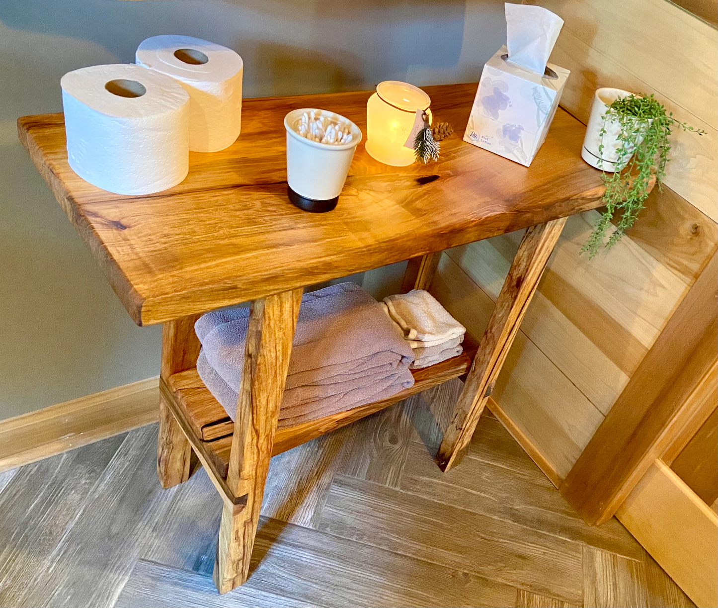 Top-down view of spalted maple sofa or console table with household items, highlighting natural wood grain, warm tones, and wood details. Handcrafted spalted maple console / sofa table styled in a modern living room with a cozy, rustic aesthetic. Detailed view of spalted maple wood grain, showing natural spalting, color variations, and organic patterns. Straight edge entryway table made from spalted maple, featuring unique grain patterns and a smooth, polished surface. Rustic and modern design.
