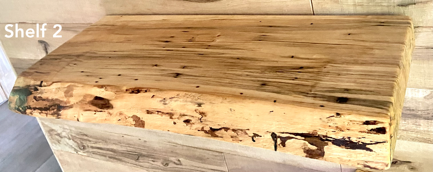 Live edge ambrosia maple floating shelf with live edge and natural grain pattern mounted on wall.