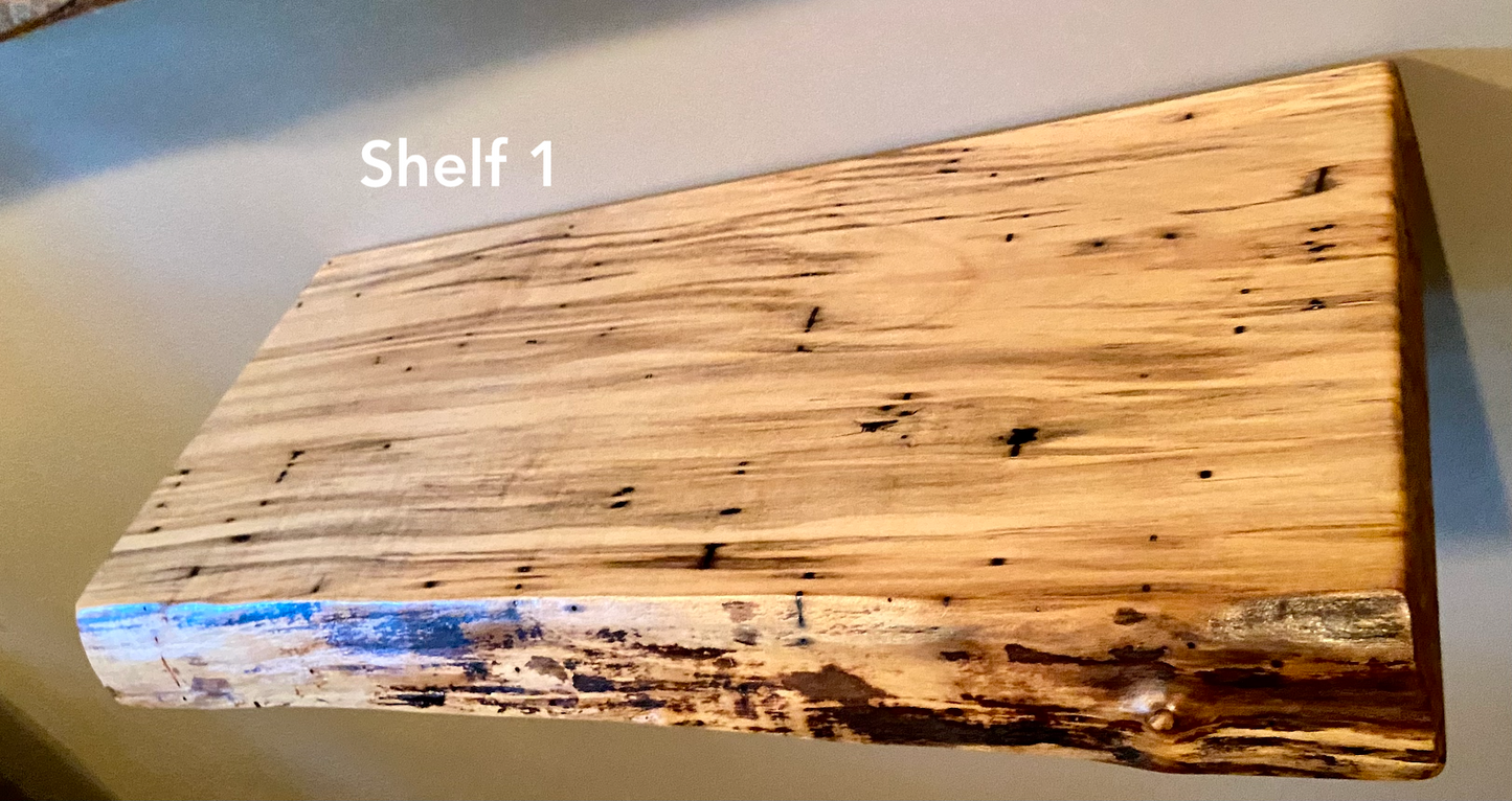 Live edge ambrosia maple floating shelf with live edge and natural grain pattern mounted on wall.