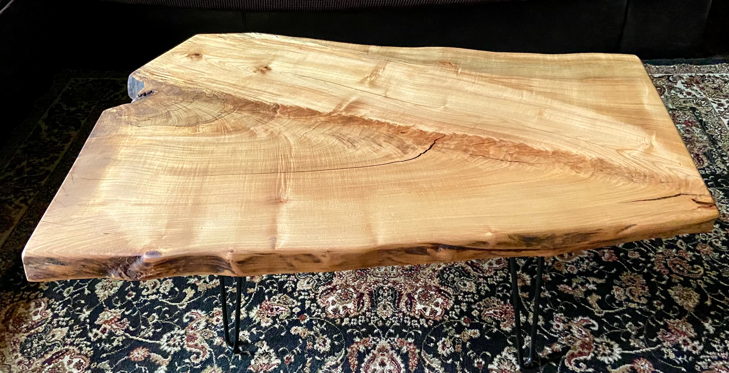 Top-down view of live edge ambrosia maple coffee table, highlighting natural wood grain, and live edge details. Handcrafted spalted maple coffee table styled in a modern living room with a cozy, rustic aesthetic. Detailed view of fiddleback maple wood grain, showing natural spalting, color variations, and organic patterns. Forked live edge coffee table made from spalted maple, featuring unique grain patterns and a smooth, polished surface. Rustic and modern design.