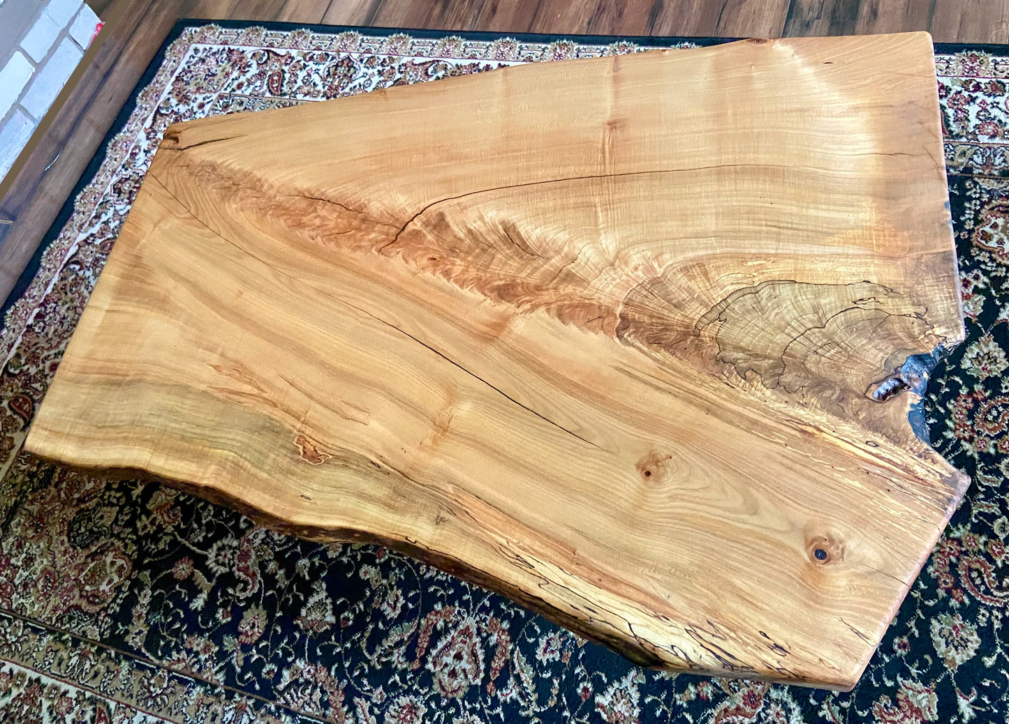 Top-down view of live edge ambrosia maple coffee table, highlighting natural wood grain, and live edge details. Handcrafted spalted maple coffee table styled in a modern living room with a cozy, rustic aesthetic. Detailed view of fiddleback maple wood grain, showing natural spalting, color variations, and organic patterns. Forked live edge coffee table made from spalted maple, featuring unique grain patterns and a smooth, polished surface. Rustic and modern design.