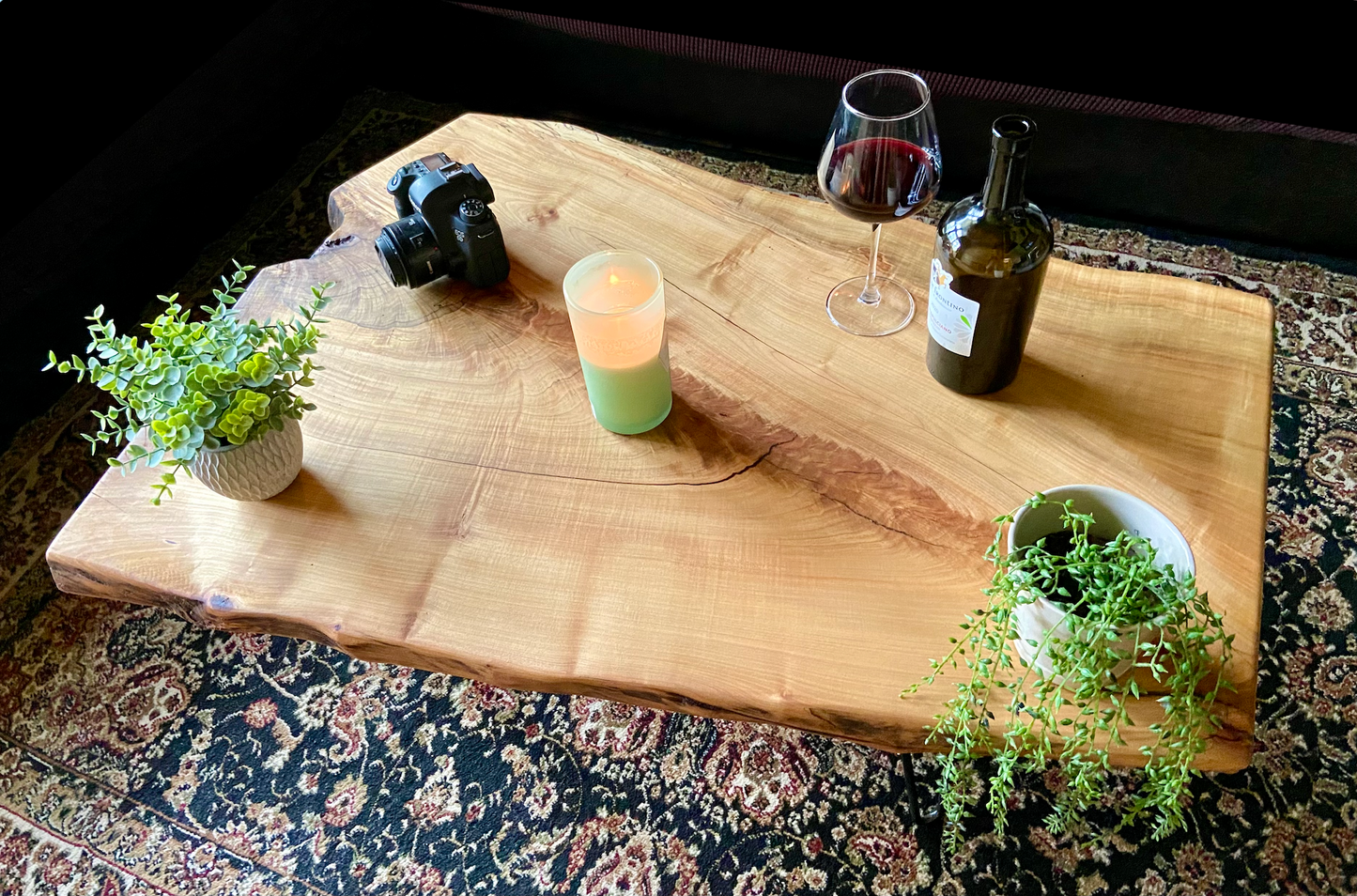 Top-down view of live edge maple coffee table with household items, highlighting natural wood grain, and live edge details. Handcrafted spalted maple coffee table styled in a modern living room with a cozy, rustic aesthetic. Detailed view of fiddleback maple wood grain, showing natural spalting, color variations, and organic patterns. Forked live edge coffee table made from spalted maple, featuring unique grain patterns and a smooth, polished surface. Rustic and modern design.