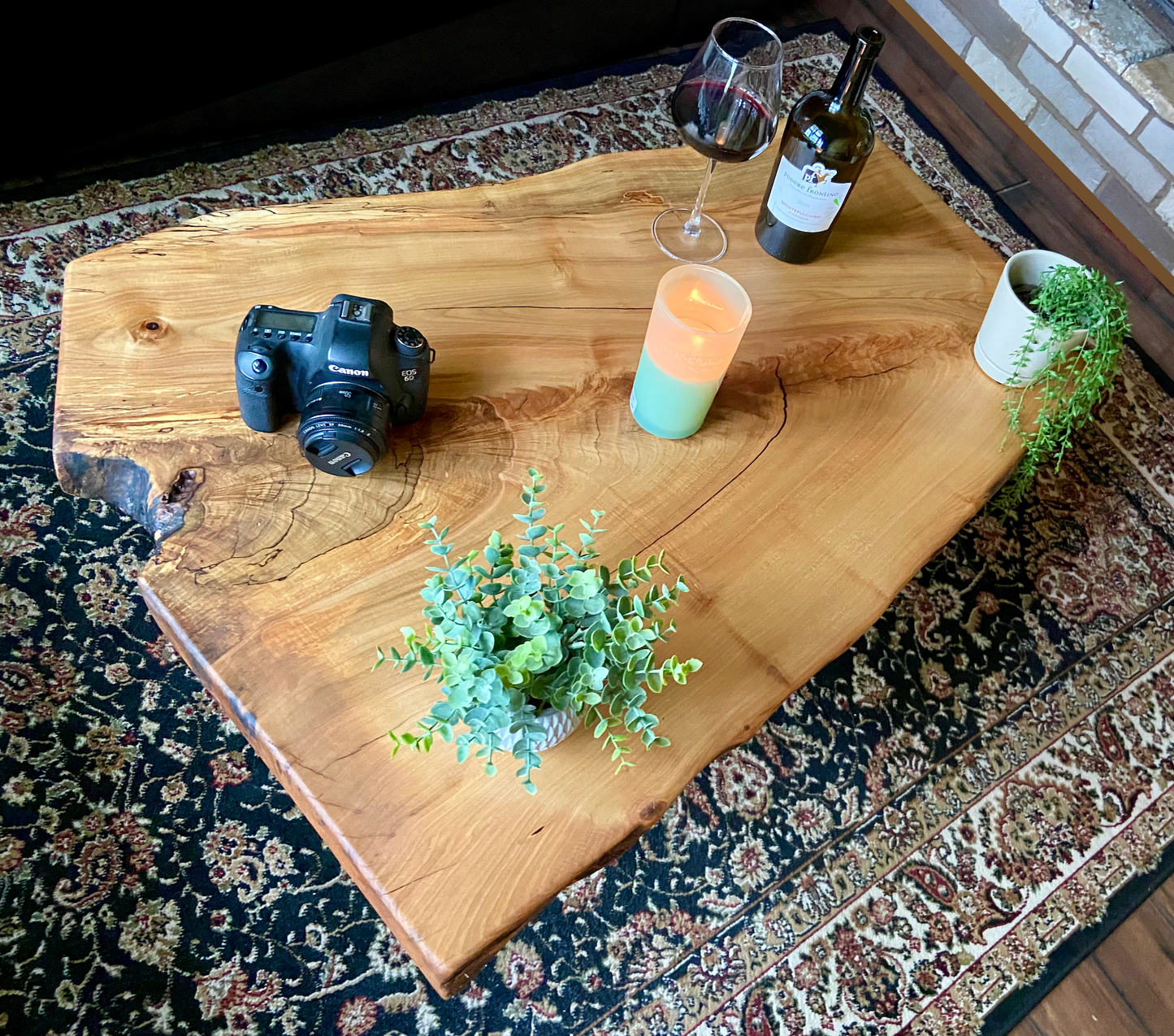 Top-down view of live edge maple coffee table with household items, highlighting natural wood grain, and live edge details. Handcrafted spalted maple coffee table styled in a modern living room with a cozy, rustic aesthetic. Detailed view of fiddleback maple wood grain, showing natural spalting, color variations, and organic patterns. Forked live edge coffee table made from spalted maple, featuring unique grain patterns and a smooth, polished surface. Rustic and modern design.