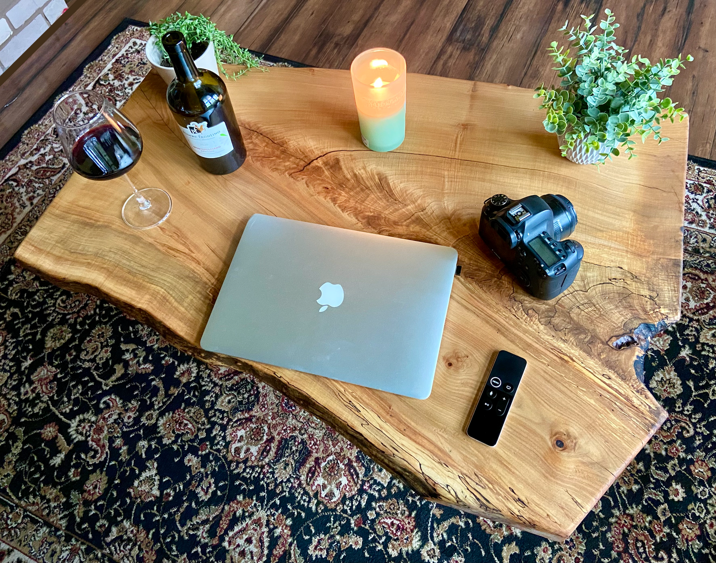 Top-down view of live edge maple coffee table with household items, highlighting natural wood grain, and live edge details. Handcrafted spalted maple coffee table styled in a modern living room with a cozy, rustic aesthetic. Detailed view of fiddleback maple wood grain, showing natural spalting, color variations, and organic patterns. Forked live edge coffee table made from spalted maple, featuring unique grain patterns and a smooth, polished surface. Rustic and modern design.