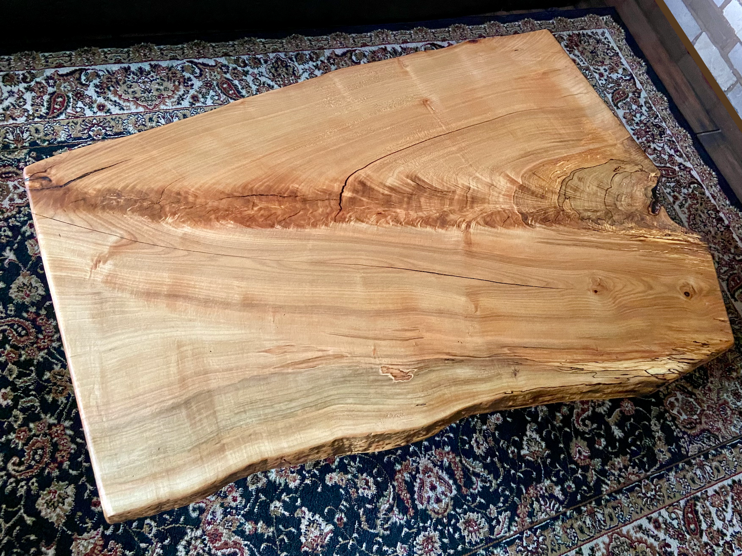 Top-down view of live edge ambrosia maple coffee table, highlighting natural wood grain, and live edge details. Handcrafted spalted maple coffee table styled in a modern living room with a cozy, rustic aesthetic. Detailed view of fiddleback maple wood grain, showing natural spalting, color variations, and organic patterns. Forked live edge coffee table made from spalted maple, featuring unique grain patterns and a smooth, polished surface. Rustic and modern design.
