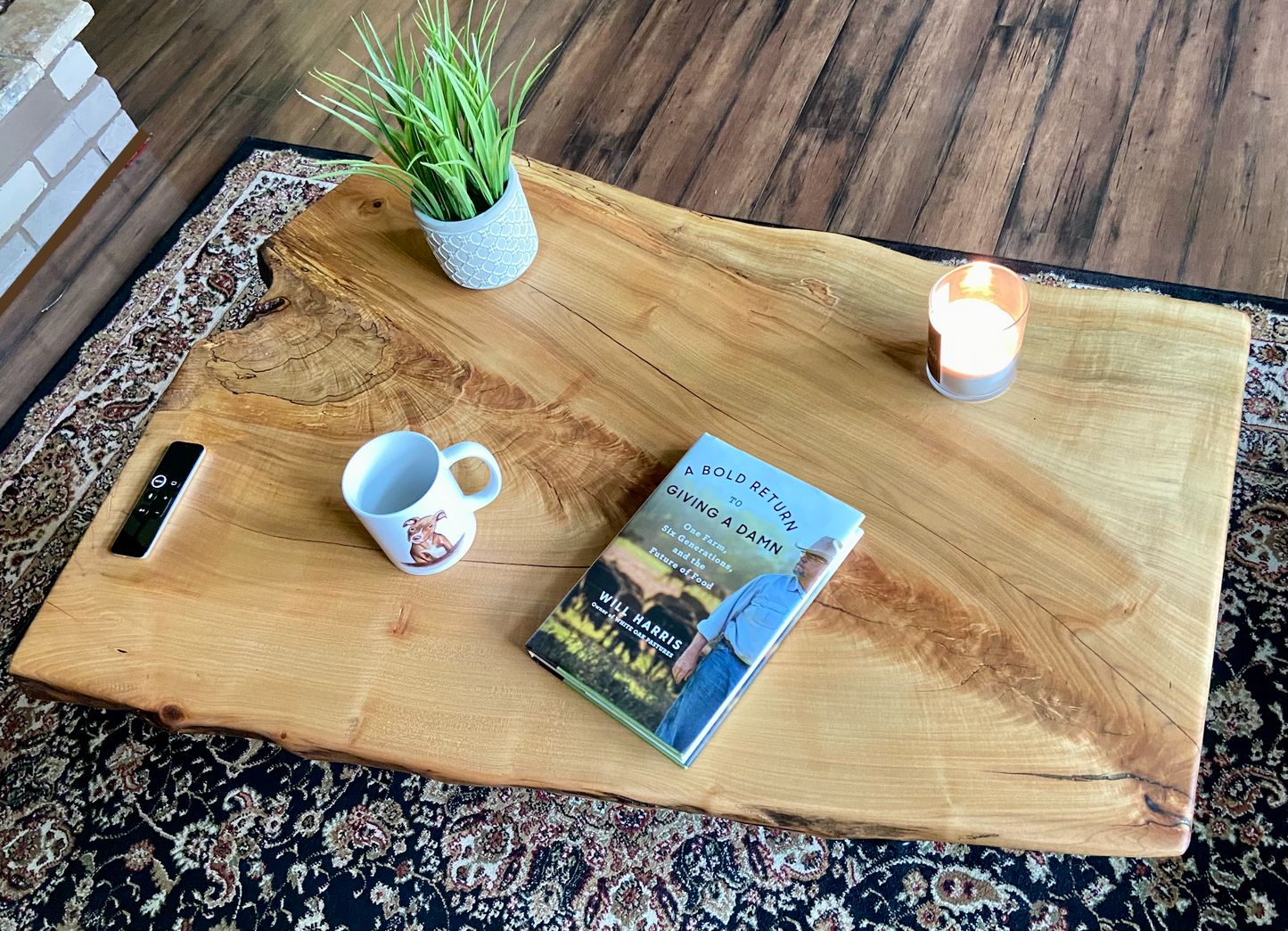 Top-down view of live edge maple coffee table with household items, highlighting natural wood grain, and live edge details. Handcrafted spalted maple coffee table styled in a modern living room with a cozy, rustic aesthetic. Detailed view of fiddleback maple wood grain, showing natural spalting, color variations, and organic patterns. Forked live edge coffee table made from spalted maple, featuring unique grain patterns and a smooth, polished surface. Rustic and modern design.