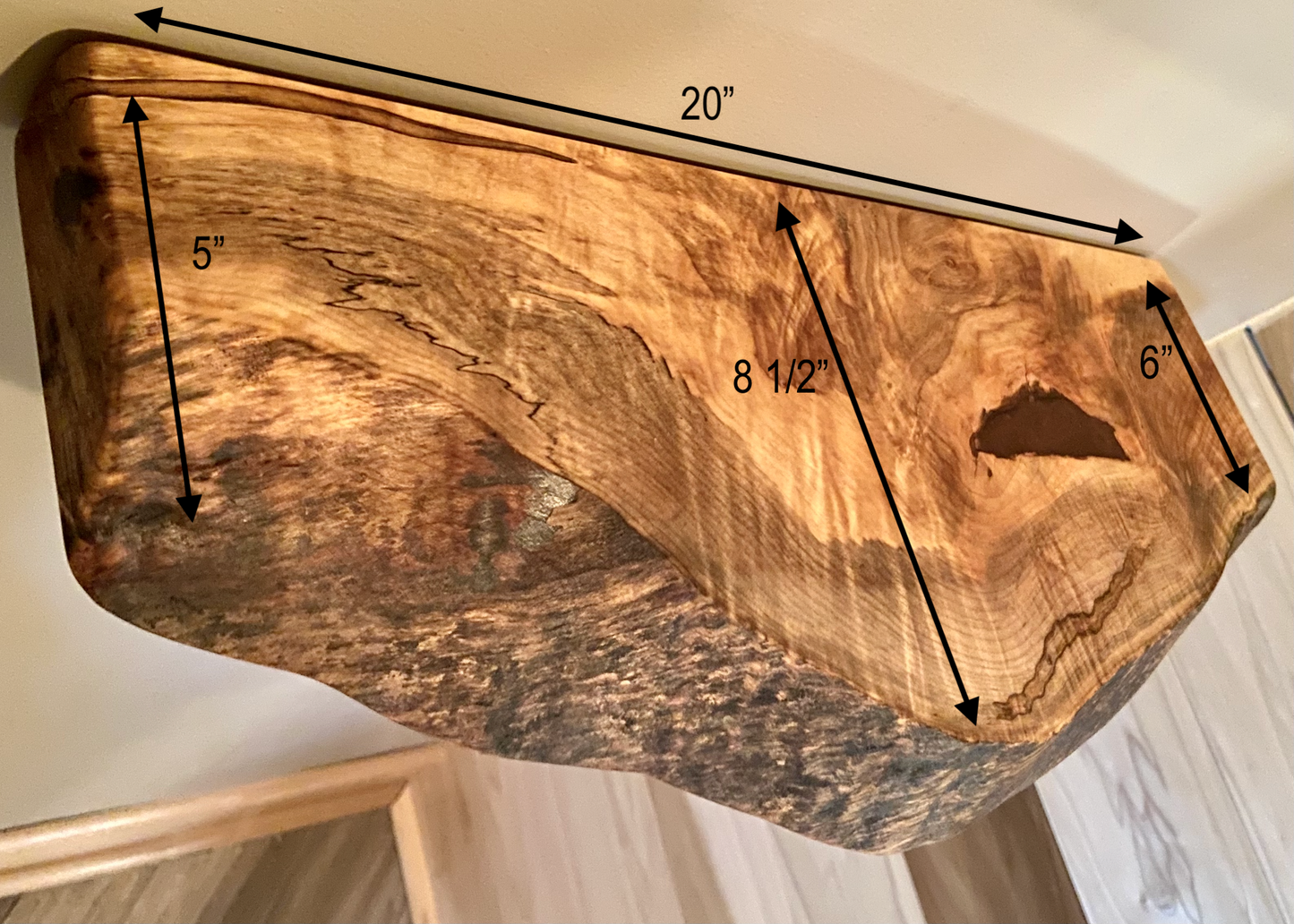 Handcrafted small live edge ambrosia maple floating shelf mounted on a wall. Close-up of the live edge detail on an ambrosia maple floating shelf, highlighting the natural wood grain and unique wormy patterns. Side view of a small ambrosia maple floating shelf with concealed brackets, showcasing its sleek, minimalist design.