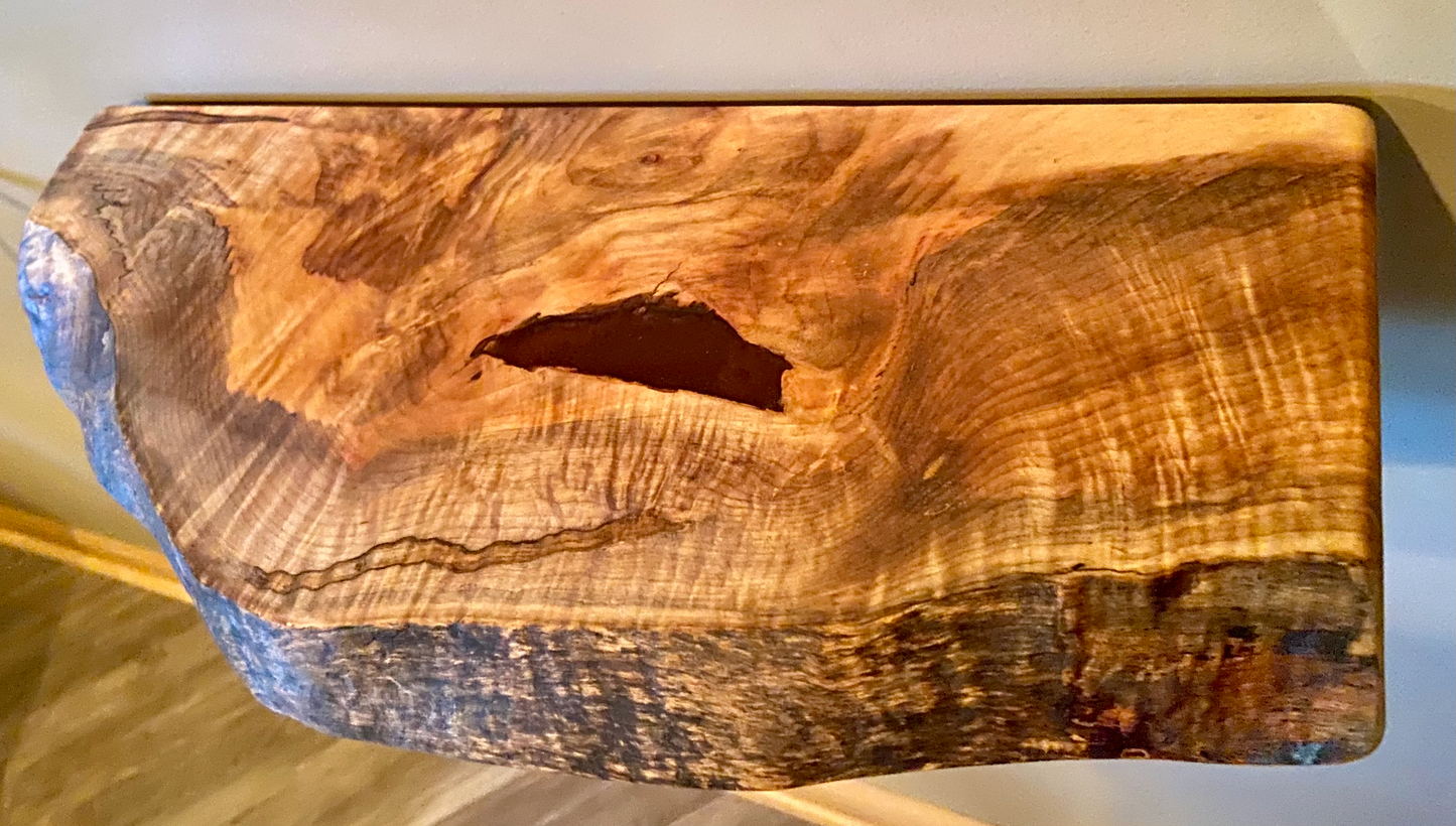 Handcrafted small live edge ambrosia maple floating shelf mounted on a wall. Close-up of the live edge detail on an ambrosia maple floating shelf, highlighting the natural wood grain and unique wormy patterns. Side view of a small ambrosia maple floating shelf with concealed brackets, showcasing its sleek, minimalist design.Epoxy