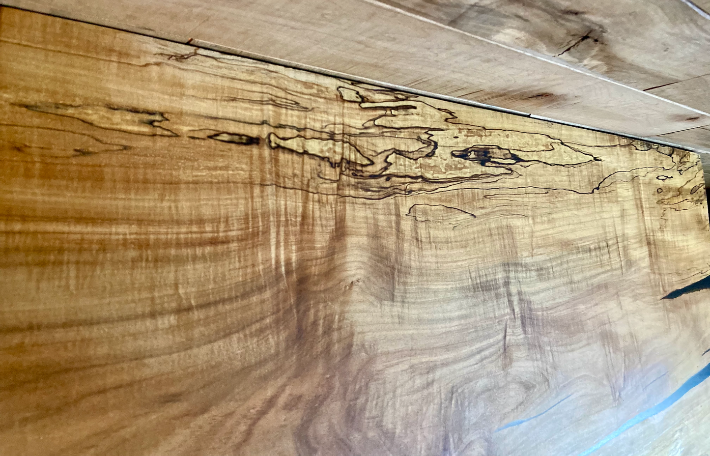 Handmade spalted hardwood vanity top with smooth finish and organic live edge front. Solid wood bathroom vanity top featuring spalted grain, knot detail, and natural character.