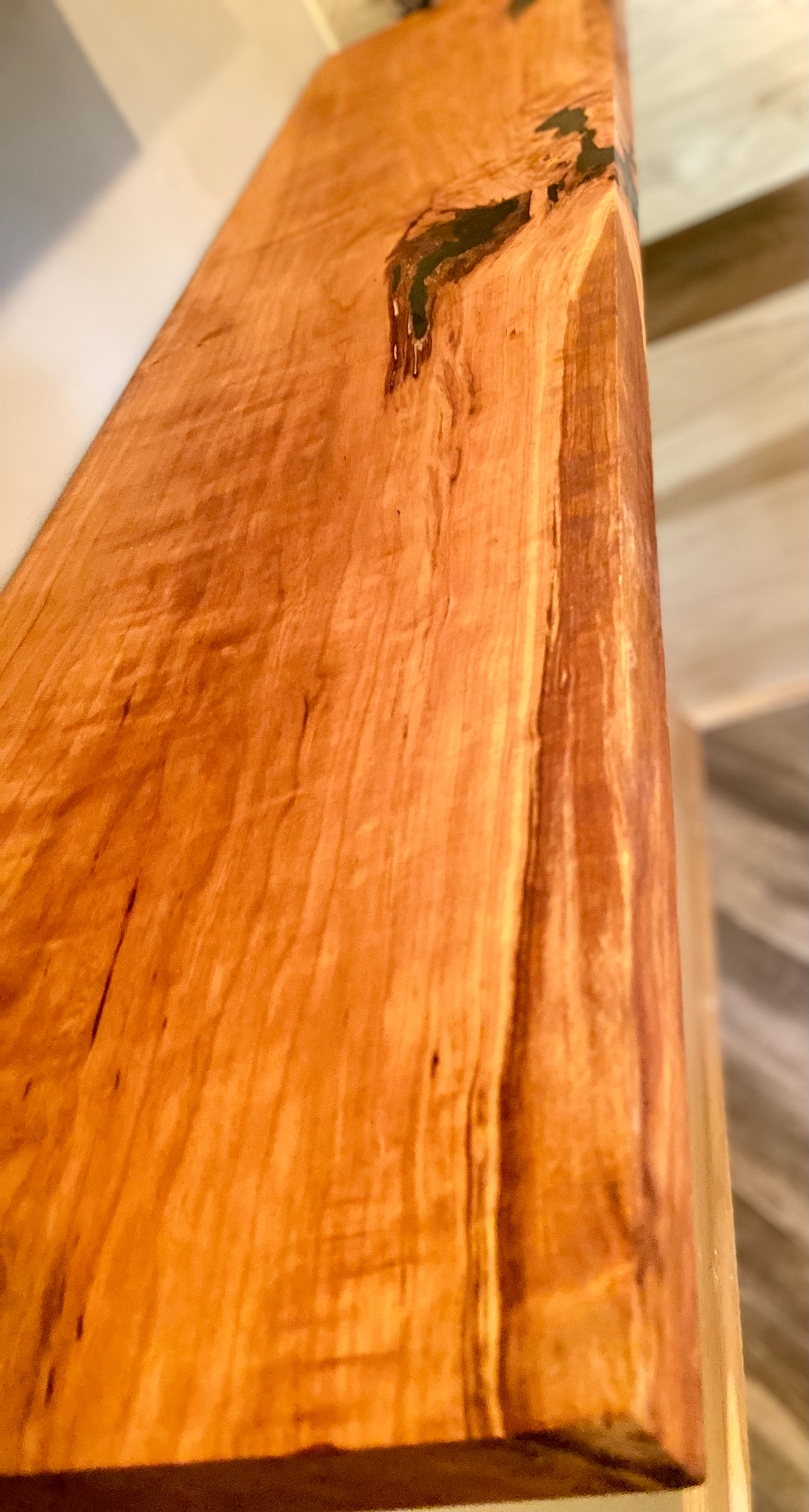 Front view of a handcrafted cherry floating shelf mounted on a wall. Close-up of the solid cherry wood grain, highlighting the shelf’s smooth finish. Side angle showcasing the shelf’s thickness and sturdy wall brackets.