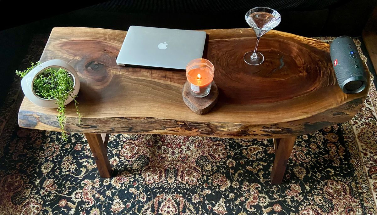 Ultra unique oval rustic natural live edge black walnut coffee table offers natural walnut wood with gorgeous grain patterns, complete with a large knot, a smaller knot, radial grain dancing around the entire table, completed with curl and a long oval shape.