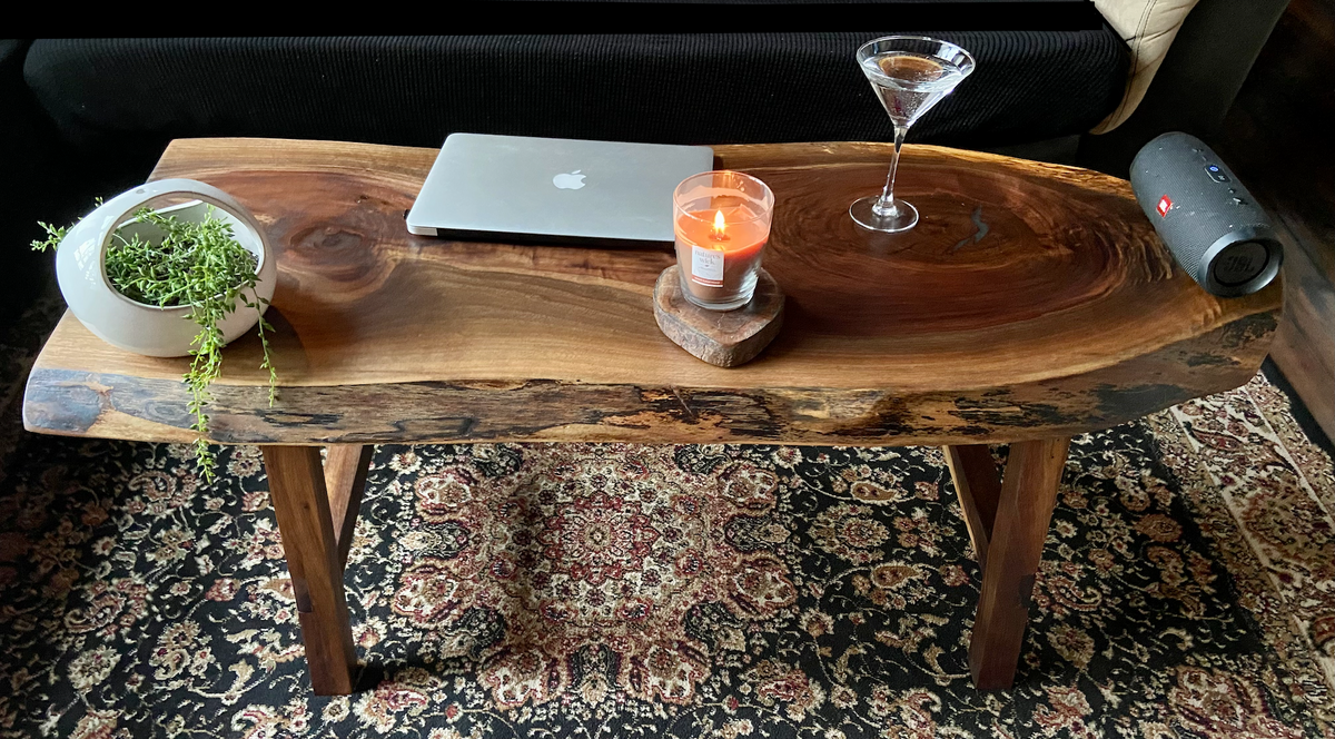 Ultra unique oval rustic natural live edge black walnut coffee table offers natural walnut wood with gorgeous grain patterns, complete with a large knot, a smaller knot, radial grain dancing around the entire table, completed with curl and a long oval shape.
