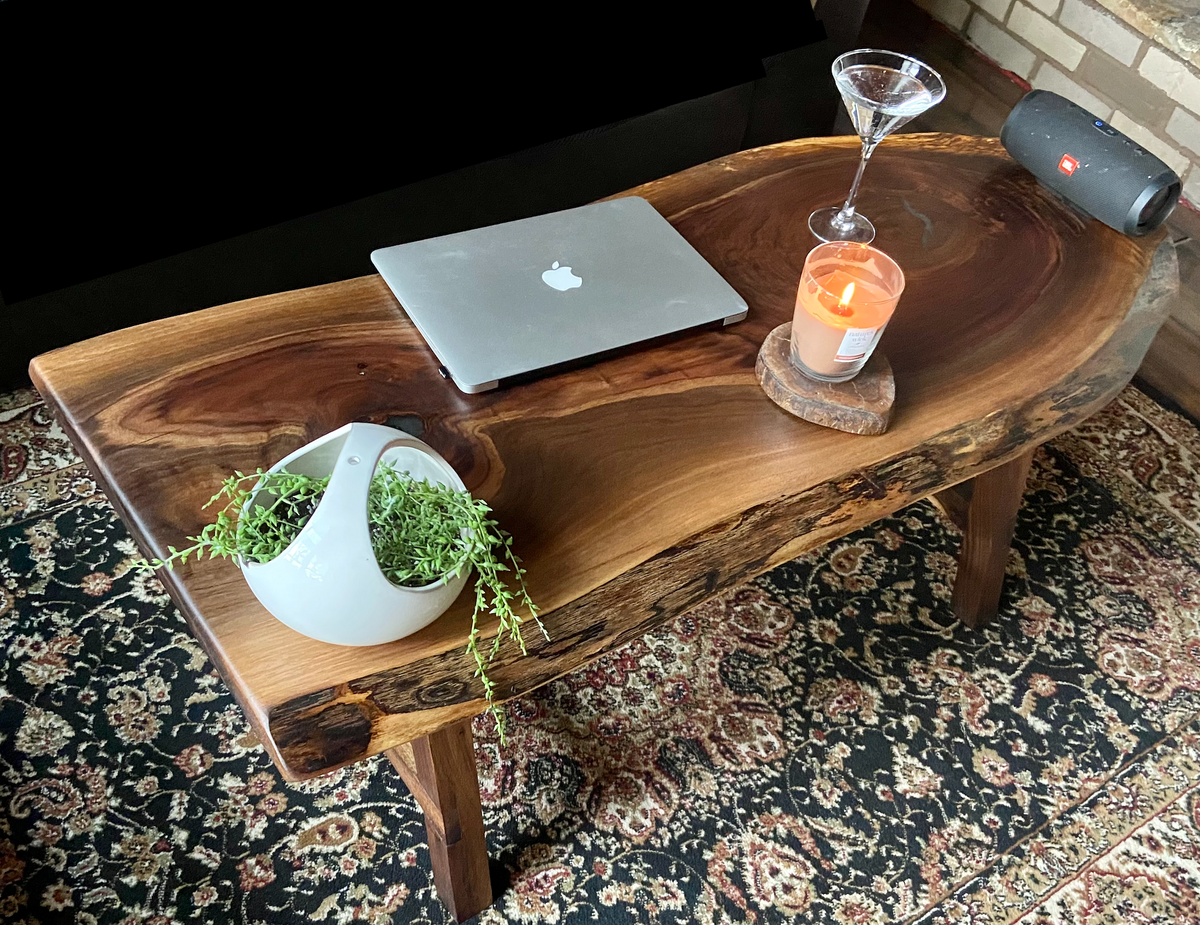 Ultra unique oval rustic natural live edge black walnut coffee table offers natural walnut wood with gorgeous grain patterns, complete with a large knot, a smaller knot, radial grain dancing around the entire table, completed with curl and a long oval shape.