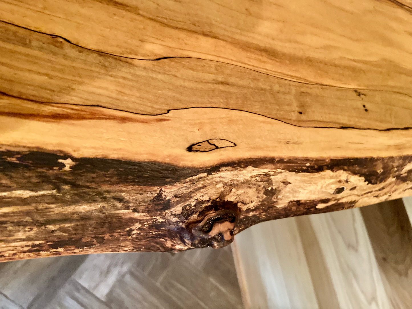 Spalted maple floating shelf with live edge, wall-mounted and handcrafted from natural wood.