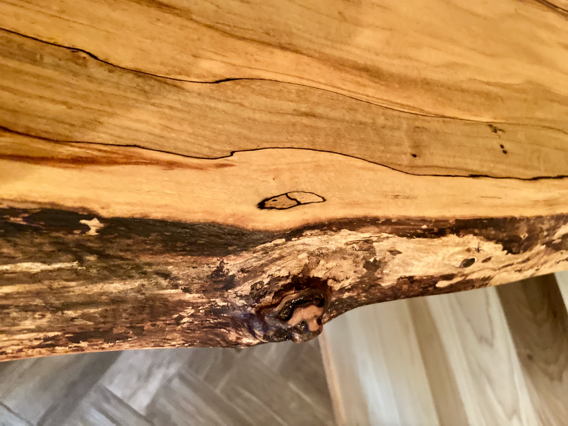 Spalted maple floating shelf with live edge, wall-mounted and handcrafted from natural wood.