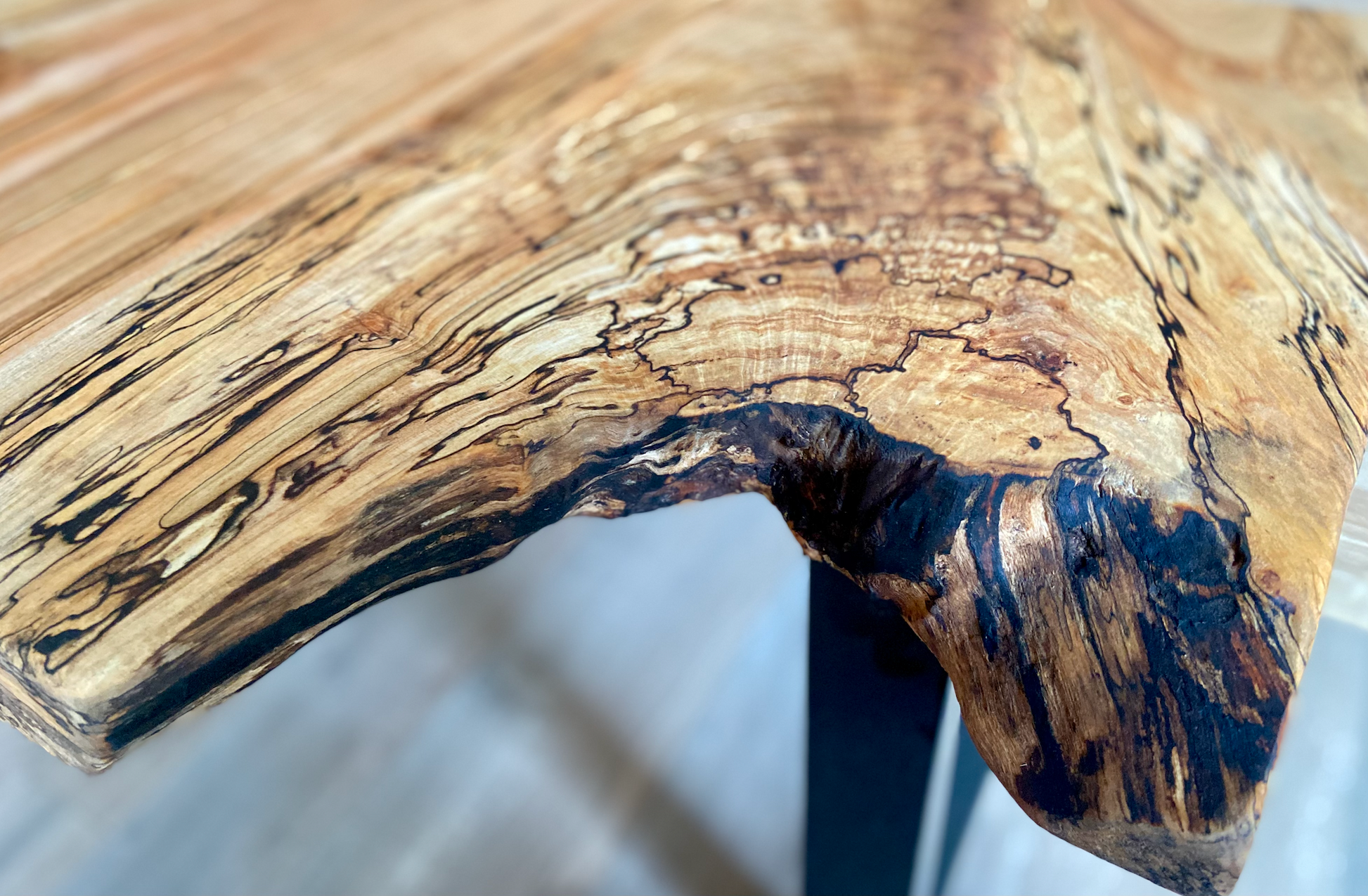 Close-up of a wooden table with a natural, rustic finish.
