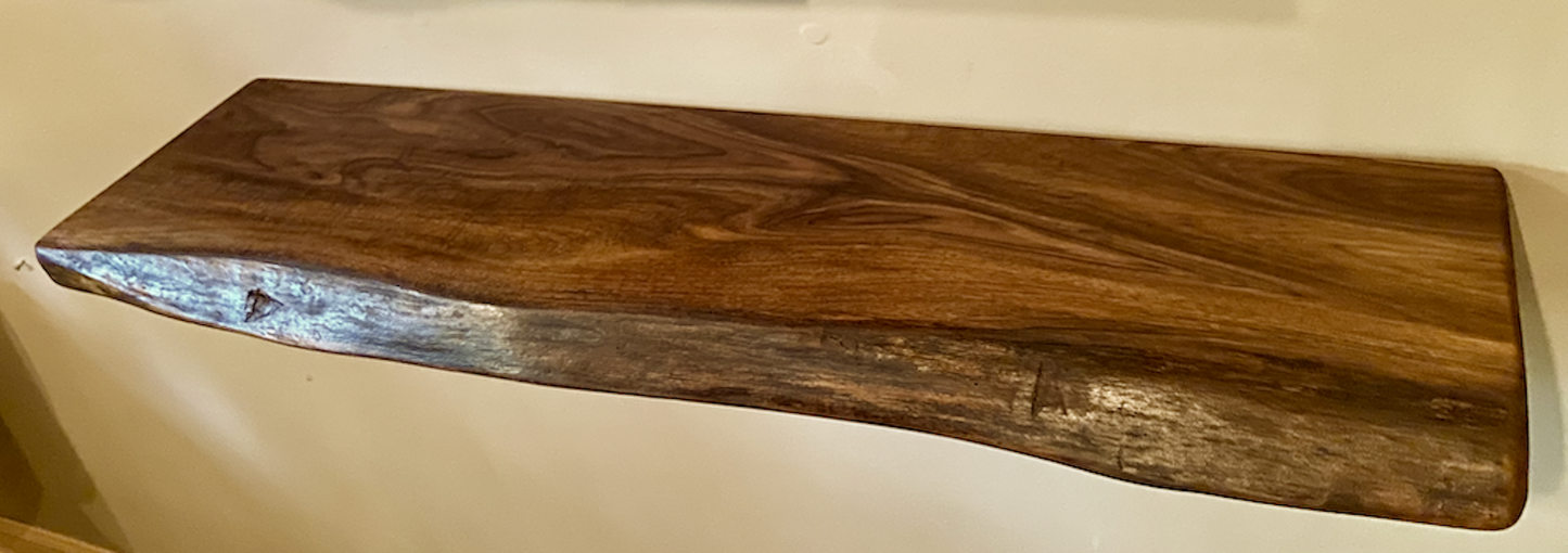 Custom live edge walnut shelves with natural wood grain, handcrafted from solid maple. Ideal for rustic, modern, or farmhouse interiors.