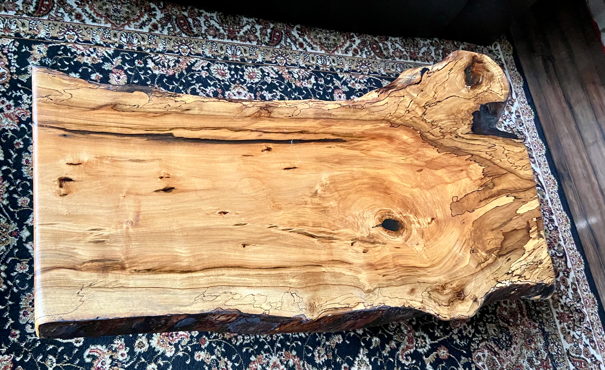 Live edge spalted ambrosia maple wood slab coffee table on a patterned rug