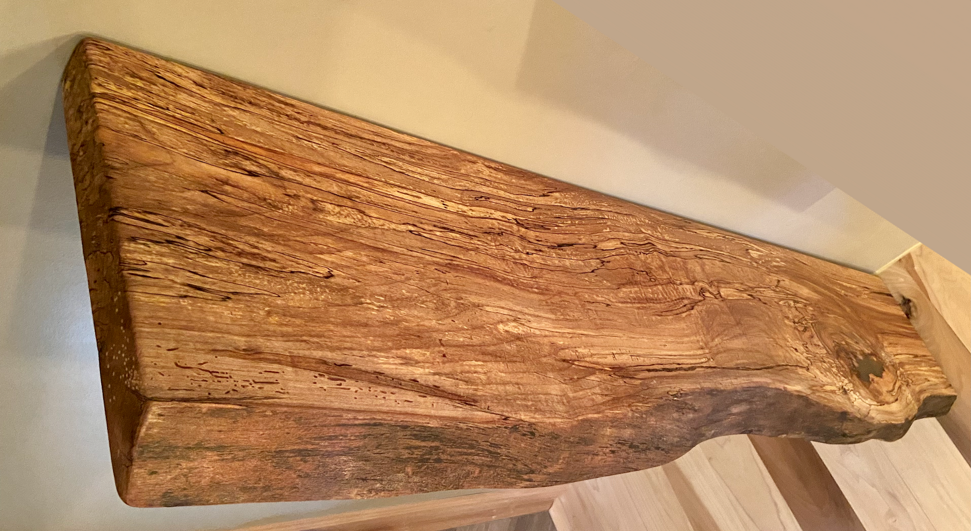 Spalted maple floating shelf with live edge, wall-mounted and handcrafted from natural wood.