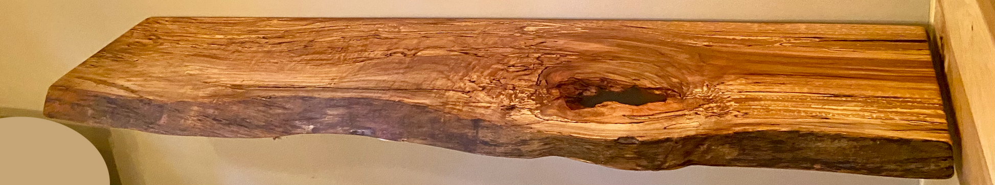 Spalted maple floating shelf with live edge, wall-mounted and handcrafted from natural wood.