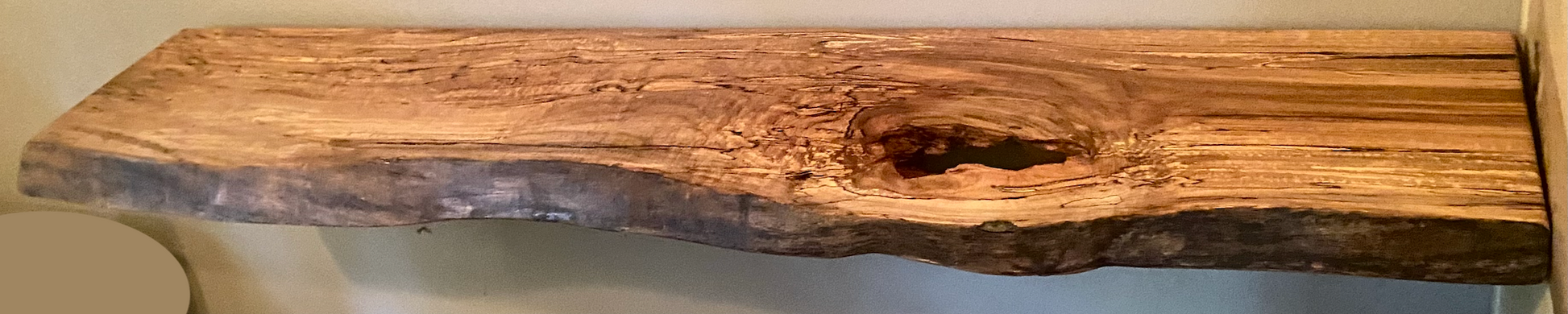 Spalted maple floating shelf with live edge, wall-mounted and handcrafted from natural wood.