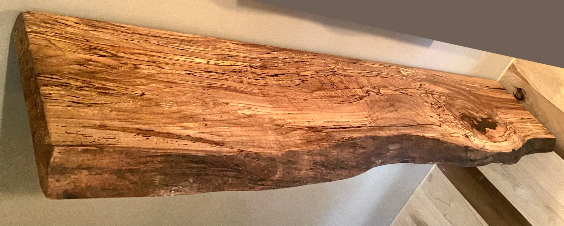 Spalted maple floating shelf with live edge, wall-mounted and handcrafted from natural wood.