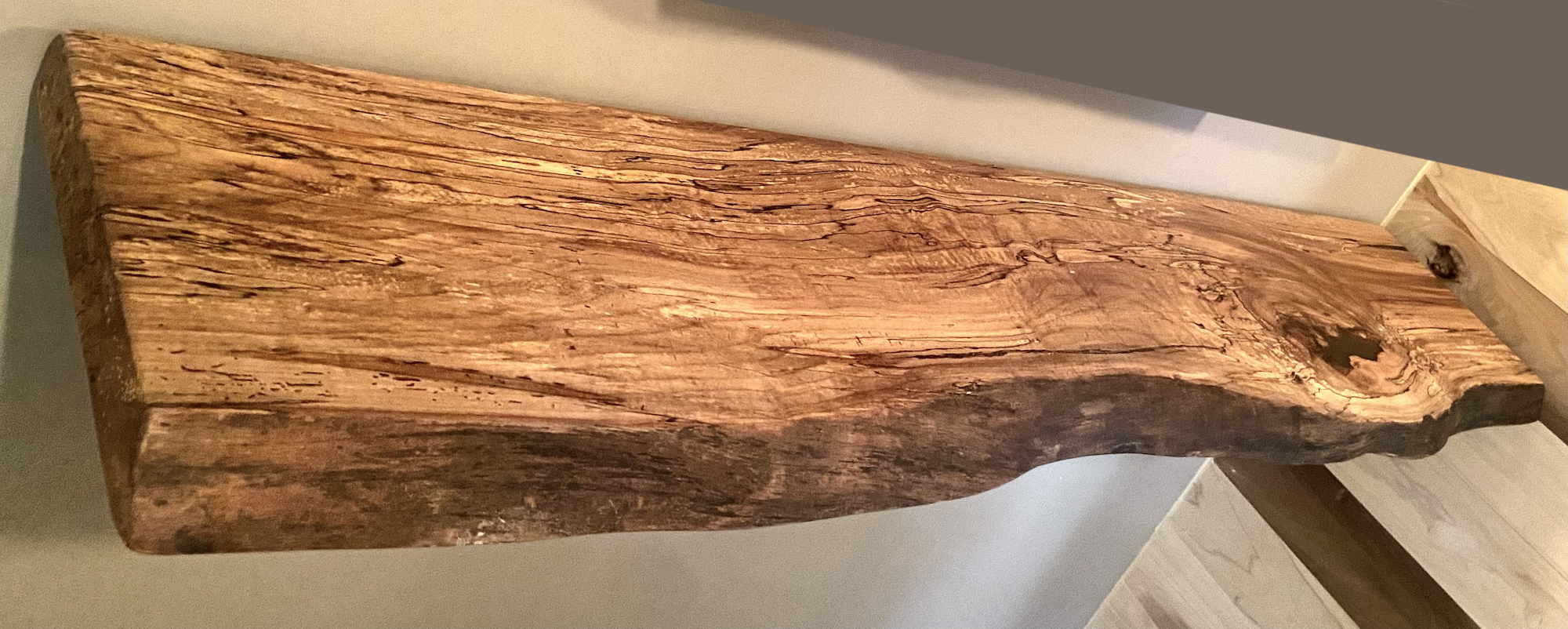 Spalted maple floating shelf with live edge, wall-mounted and handcrafted from natural wood.