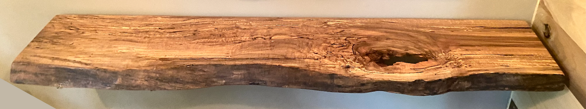 Spalted maple floating shelf with live edge, wall-mounted and handcrafted from natural wood.