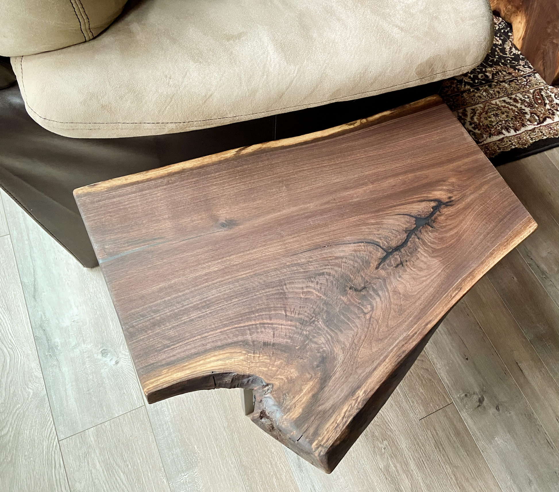 Close up of live edge walnut side table highlighting grain pattern and natural edge.