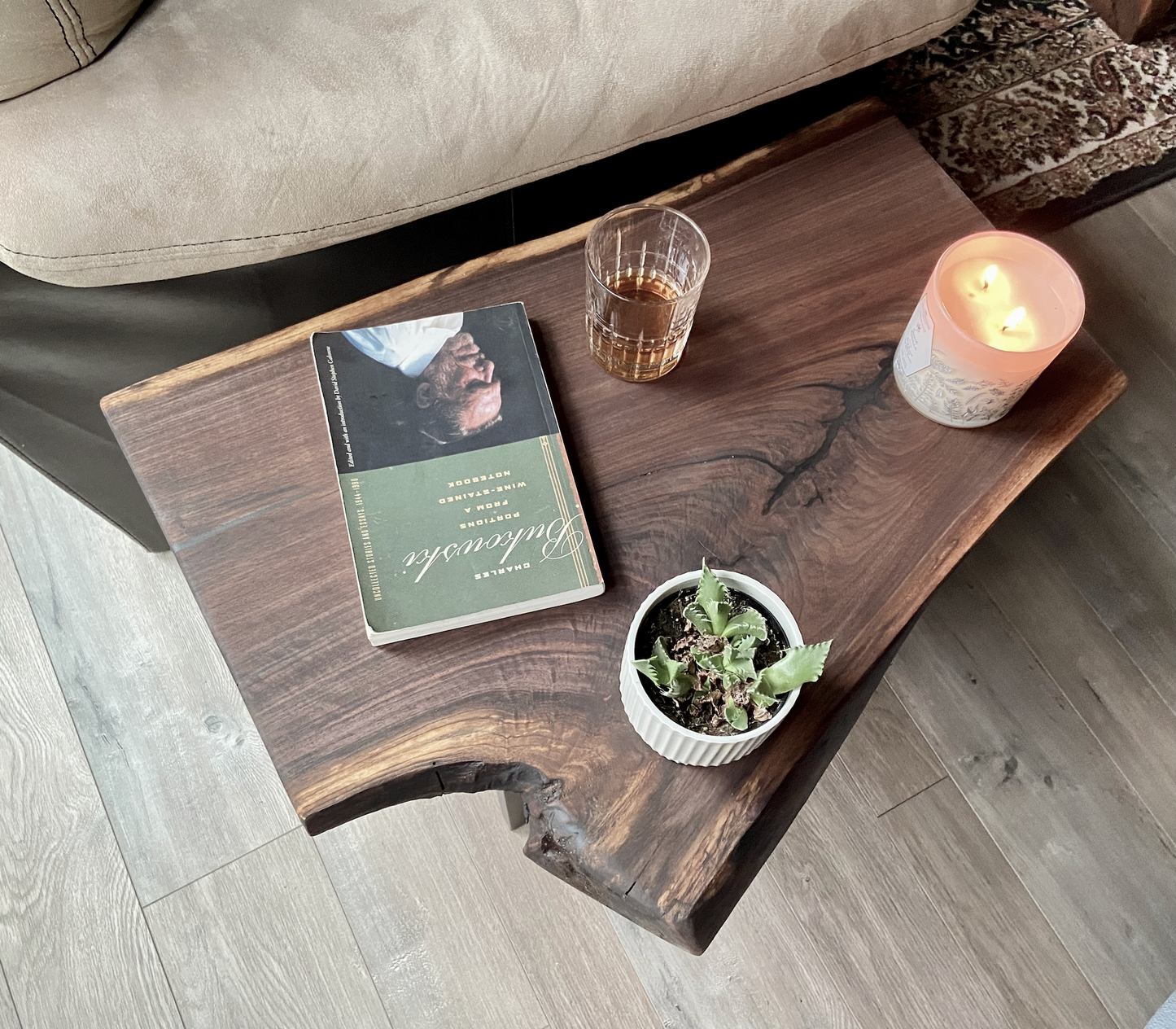 Close up of live edge walnut side table highlighting grain pattern and natural edge. Overhead view of live edge walnut end table styled with every day household items.