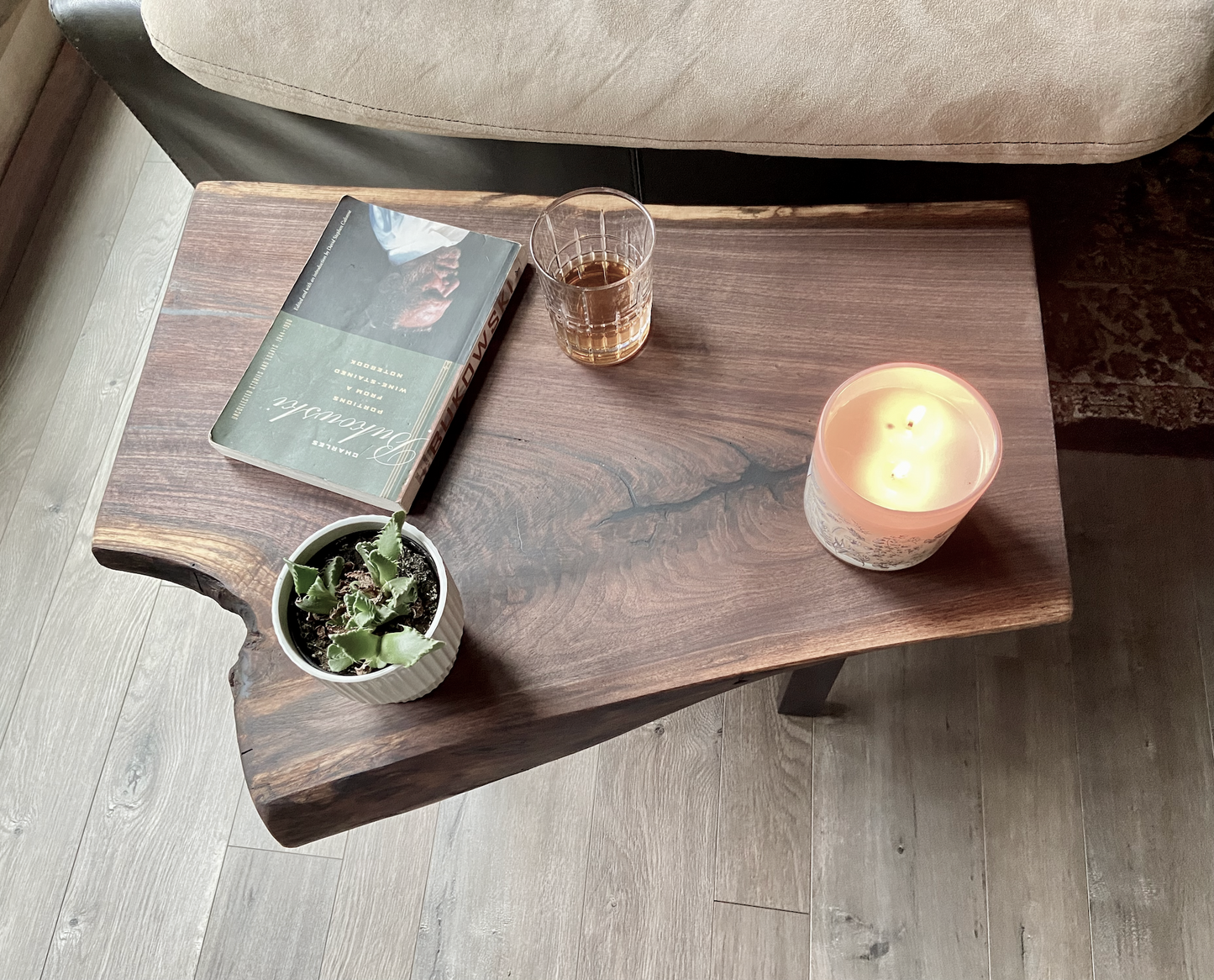 Close up of live edge walnut side table highlighting grain pattern and natural edge. Overhead view of live edge walnut end table styled with every day household items.
