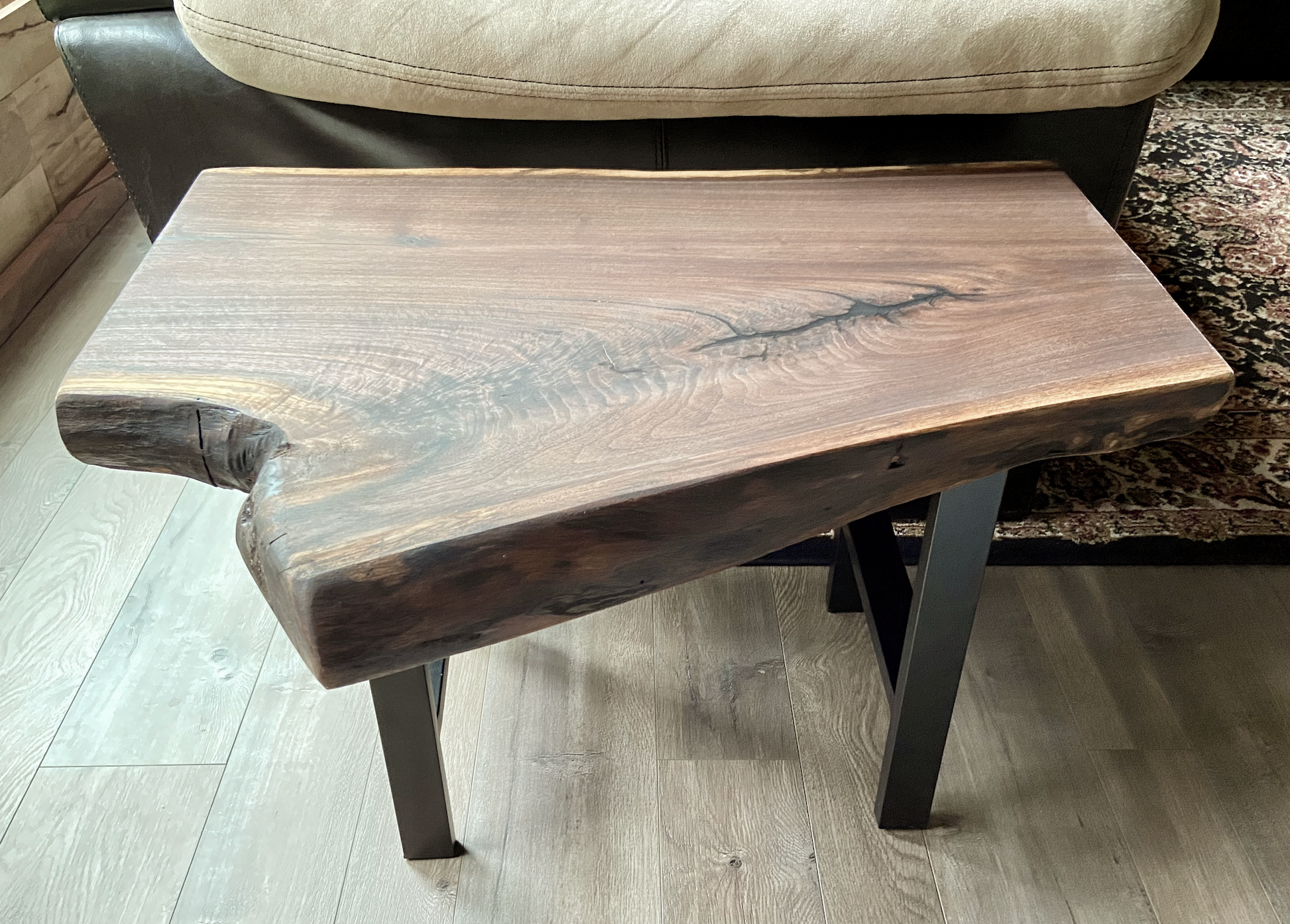 Close up of live edge walnut side table highlighting grain pattern and natural edge.