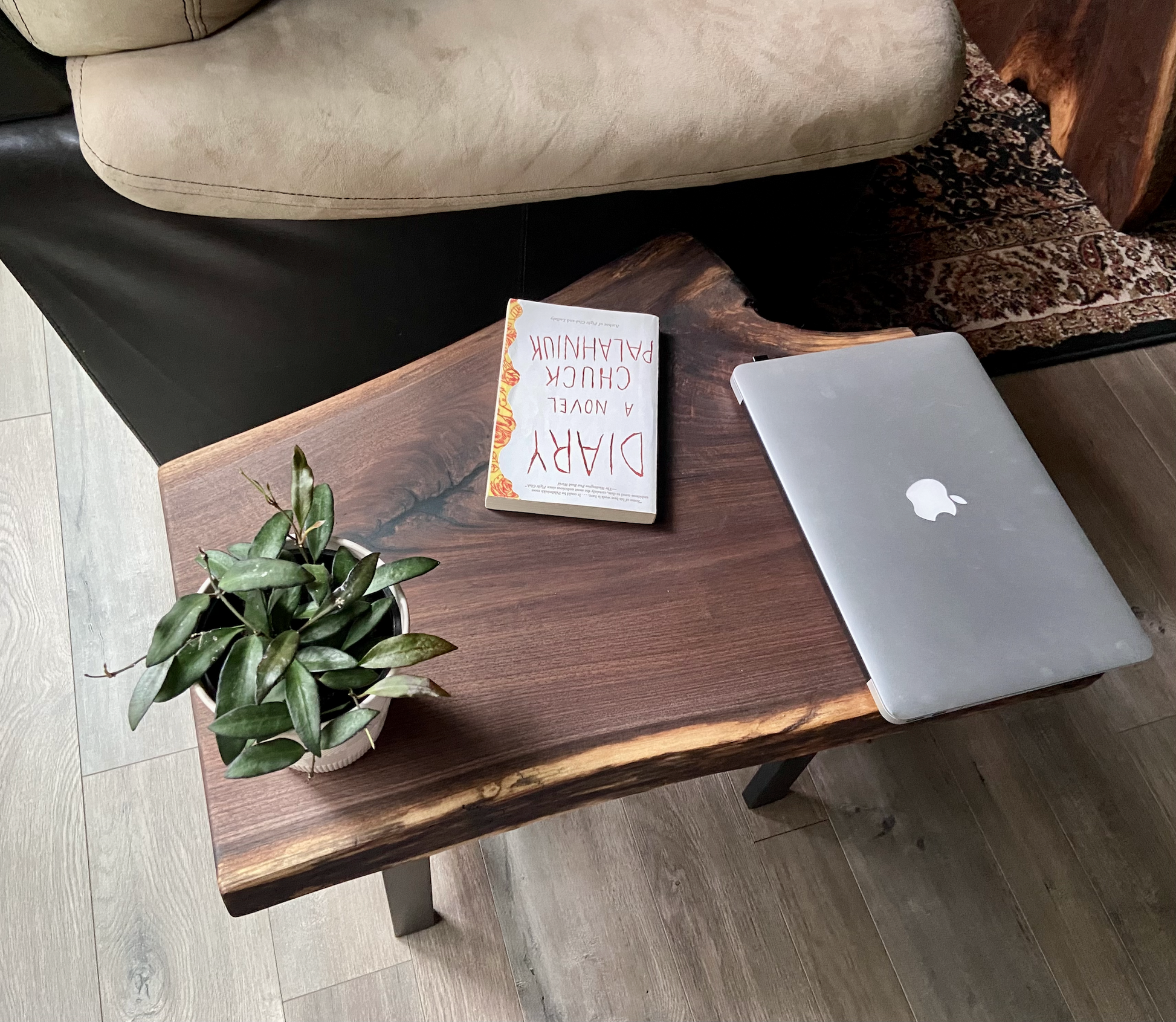 Close up of live edge walnut side table highlighting grain pattern and natural edge. Overhead view of live edge walnut end table styled with every day household items.