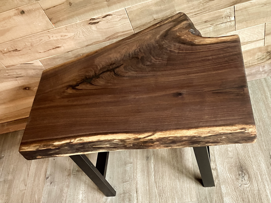 Close up of live edge walnut side table highlighting grain pattern and natural edge.