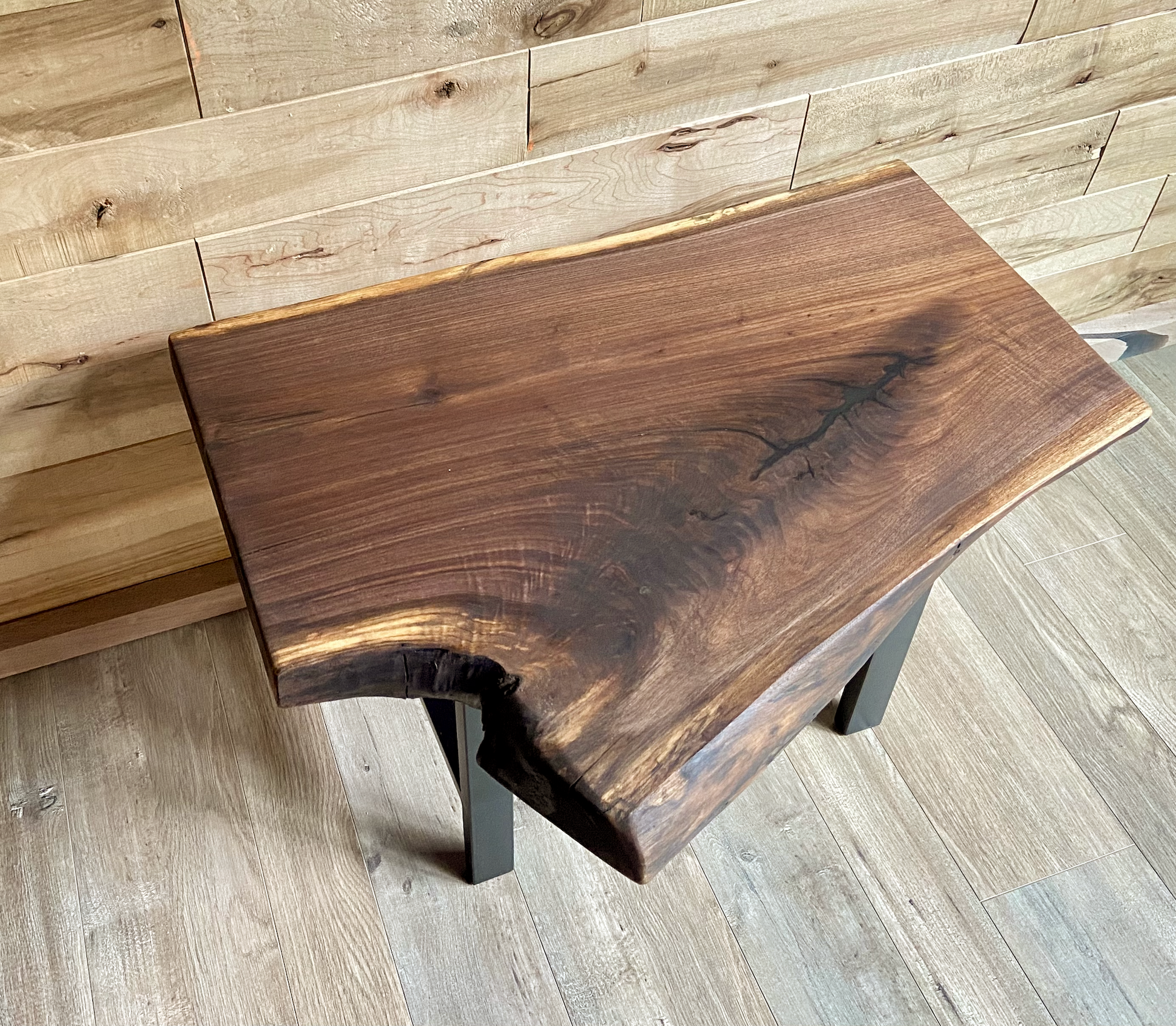 Close up of live edge walnut side table highlighting grain pattern and natural edge.