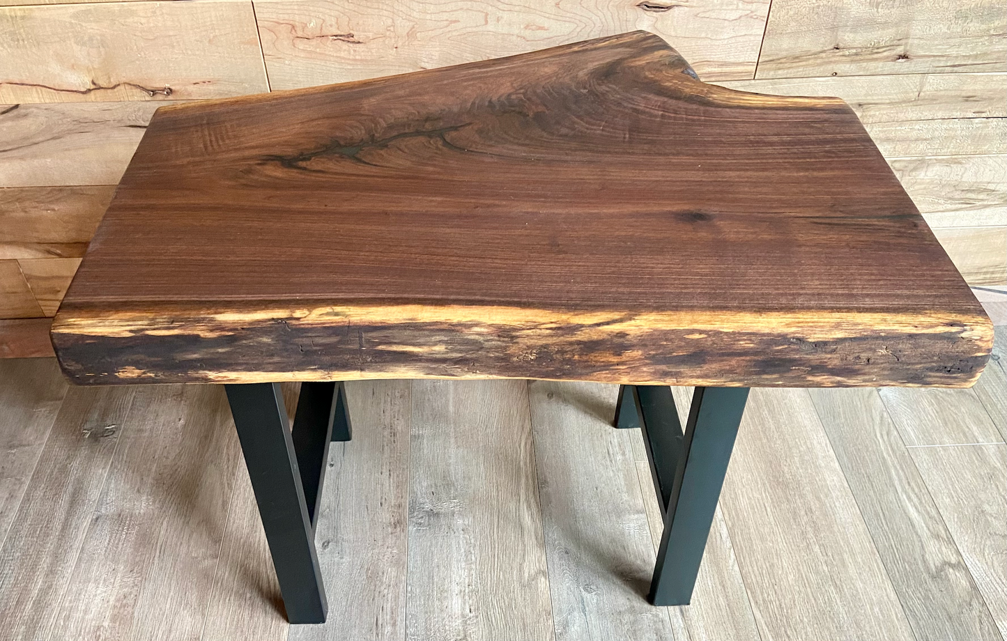 Close up of live edge walnut side table highlighting grain pattern and natural edge.