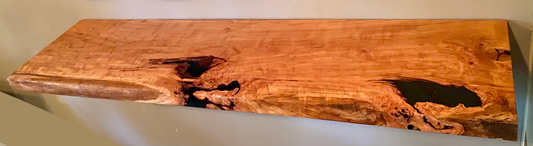 Front view of a handcrafted cherry floating shelf mounted on a wall. Close-up of the solid cherry wood grain, highlighting the shelf’s smooth finish. Side angle showcasing the shelf’s thickness and sturdy wall brackets.