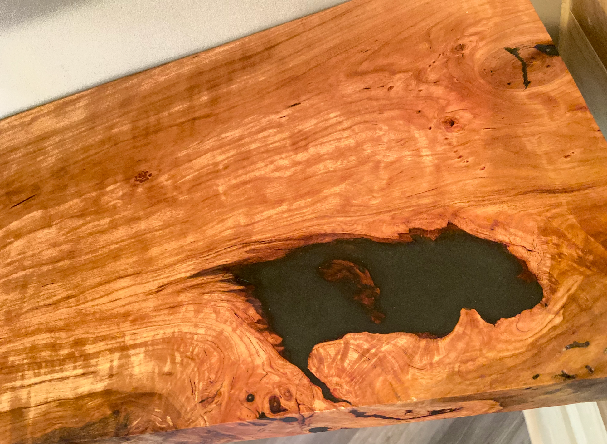 Front view of a handcrafted cherry floating shelf mounted on a wall. Close-up of the solid cherry wood grain, highlighting the shelf’s smooth finish. Side angle showcasing the shelf’s thickness and sturdy wall brackets.